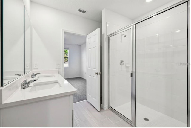 bathroom with vanity and a shower with shower door