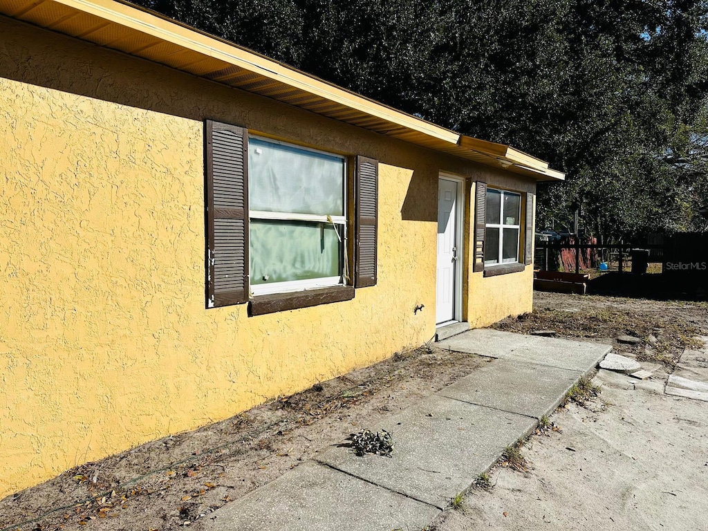 view of side of property featuring a patio area