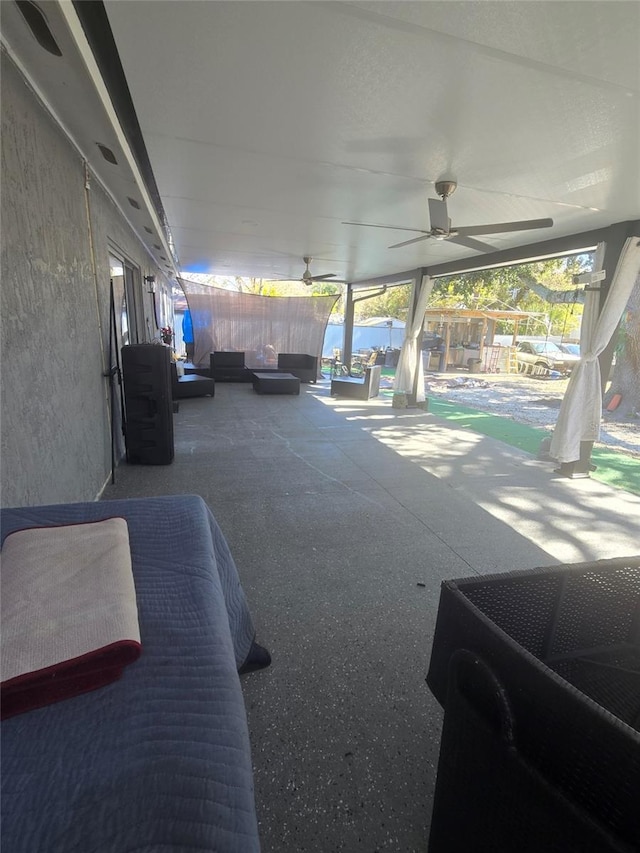 view of patio / terrace with ceiling fan and a swimming pool