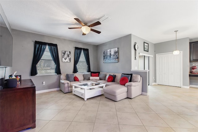 tiled living room featuring ceiling fan