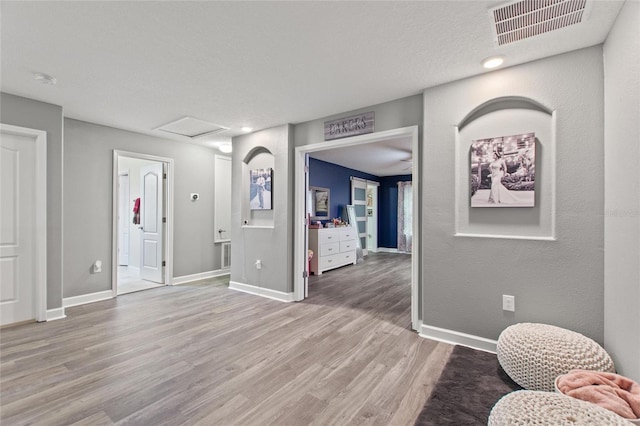 entrance foyer with a textured ceiling and light wood-type flooring