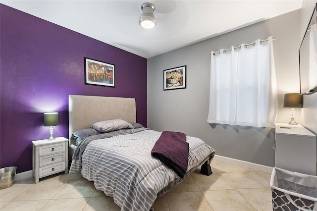 tiled bedroom featuring ceiling fan