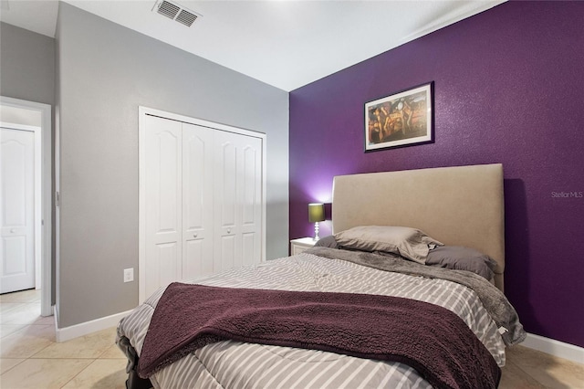 tiled bedroom with a closet