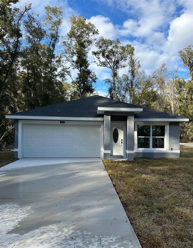 view of front of home featuring a garage and a front lawn