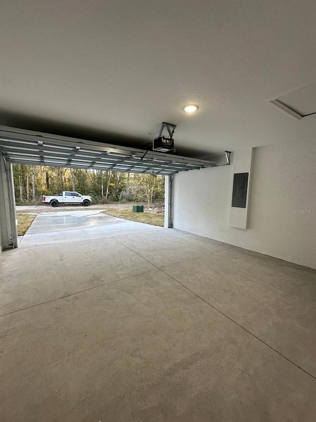 garage featuring a garage door opener and electric panel