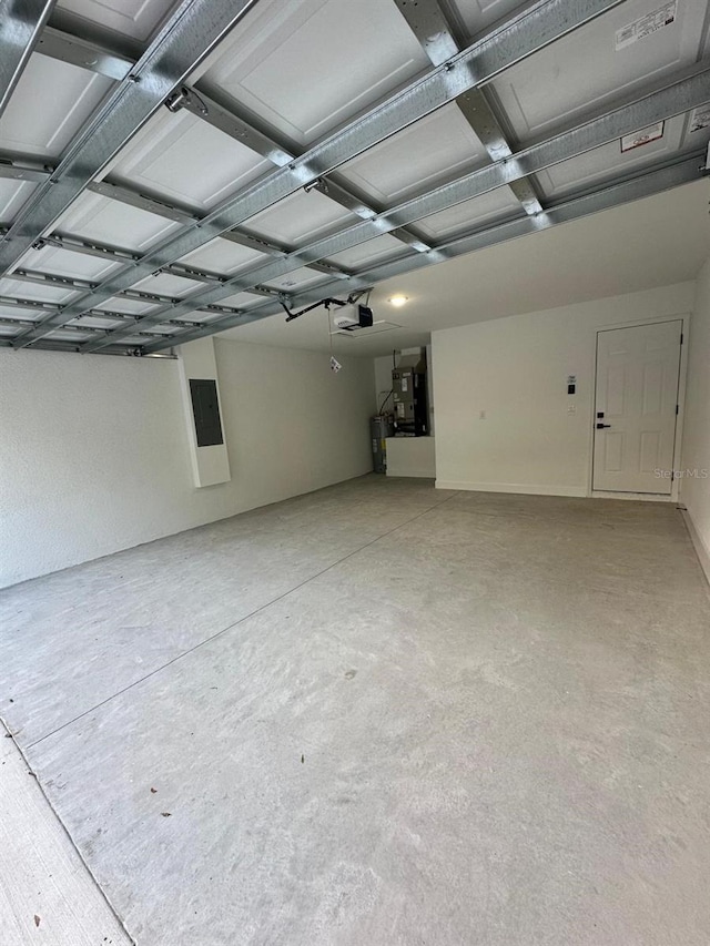 garage with a garage door opener and electric panel