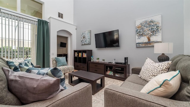 living room featuring a high ceiling