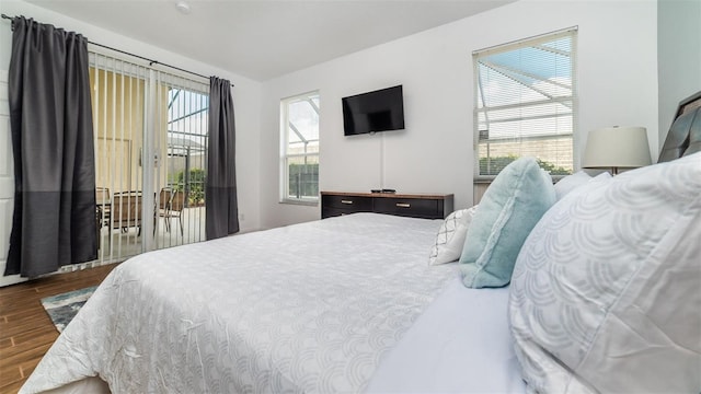 bedroom featuring wood-type flooring and access to outside