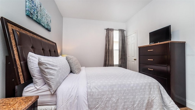 bedroom featuring vaulted ceiling