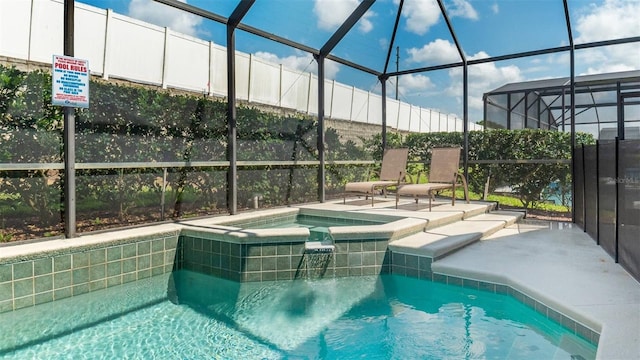 view of swimming pool featuring an in ground hot tub, a lanai, and a patio