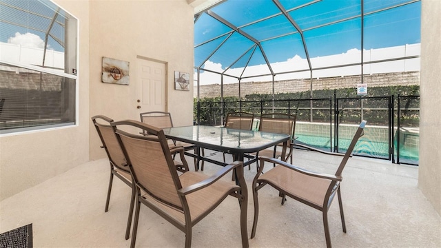 view of patio featuring glass enclosure