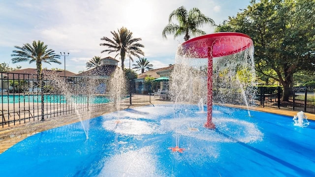 view of swimming pool with pool water feature