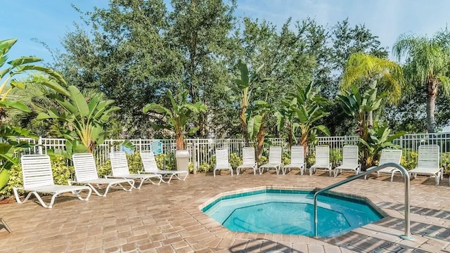 view of pool featuring a community hot tub and a patio area