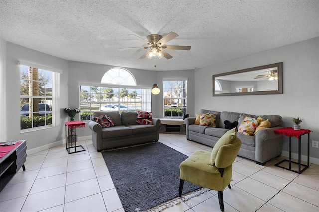 tiled living room with ceiling fan and a textured ceiling