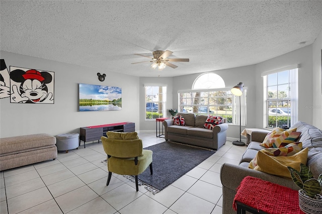 living room featuring light tile patterned floors, a textured ceiling, and ceiling fan