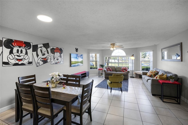 dining area with light tile patterned floors, a textured ceiling, and ceiling fan