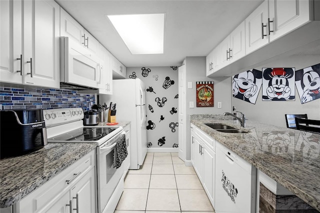 kitchen featuring sink, white appliances, white cabinetry, light stone counters, and light tile patterned flooring