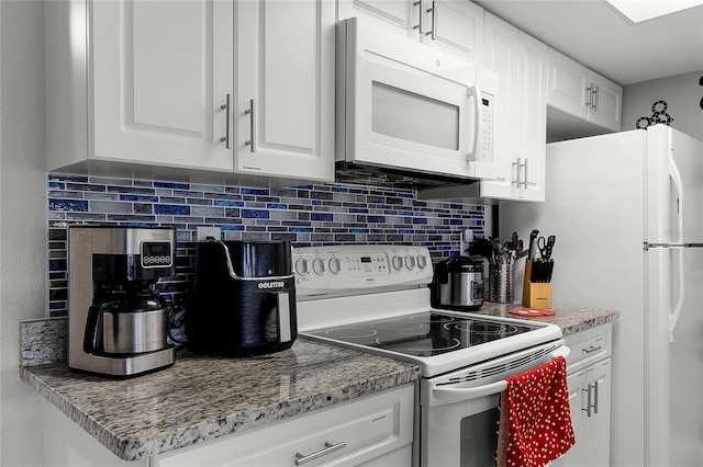 kitchen with white cabinetry, white appliances, light stone counters, and decorative backsplash