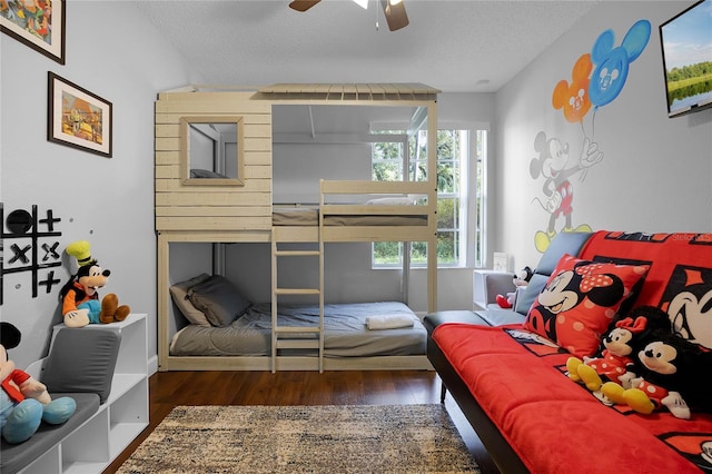 bedroom with dark hardwood / wood-style floors, a textured ceiling, and ceiling fan