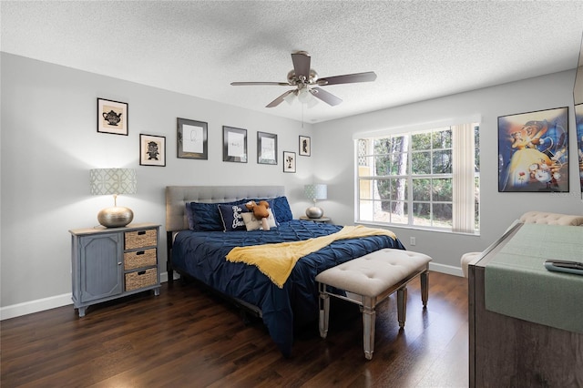 bedroom featuring dark hardwood / wood-style flooring, a textured ceiling, and ceiling fan