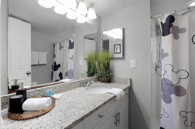 bathroom with vanity and a textured ceiling