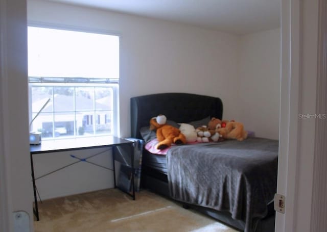 bedroom featuring light carpet