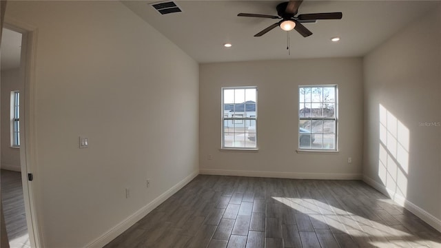 spare room with hardwood / wood-style floors and ceiling fan