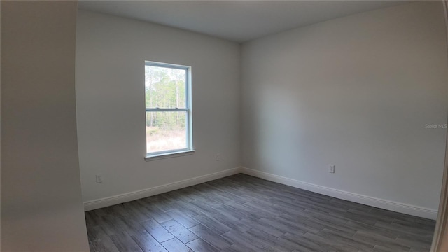 unfurnished room featuring dark hardwood / wood-style flooring