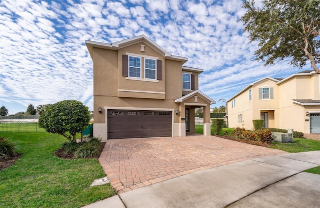 view of front of house featuring a garage and a front lawn