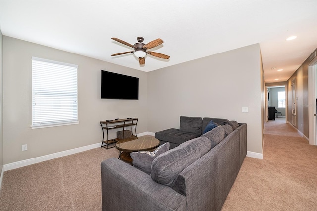 carpeted living room featuring ceiling fan