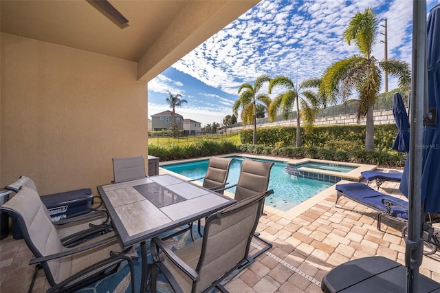 view of swimming pool featuring an in ground hot tub and a patio