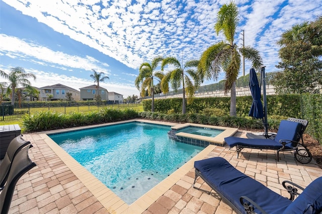 view of pool with an in ground hot tub and a patio area