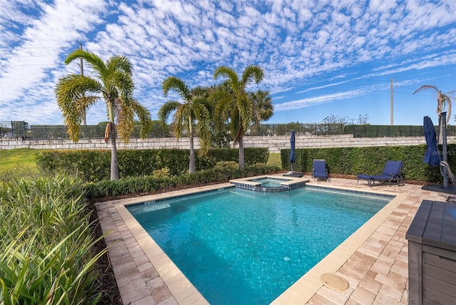 view of pool with an in ground hot tub