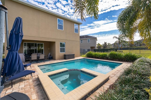 view of pool featuring an in ground hot tub and a patio area