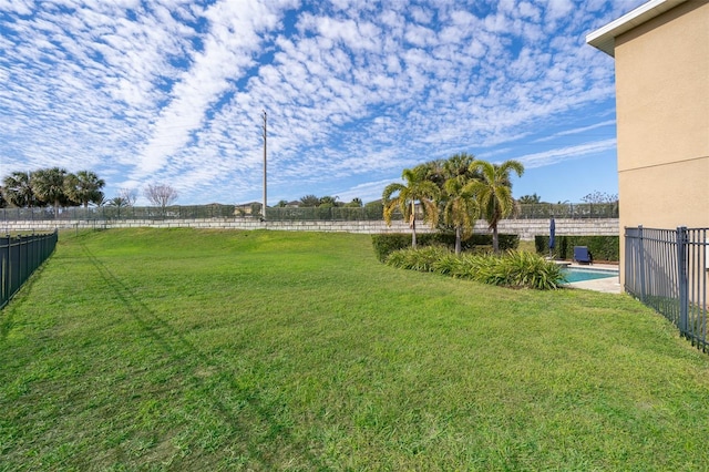 view of yard with a fenced in pool