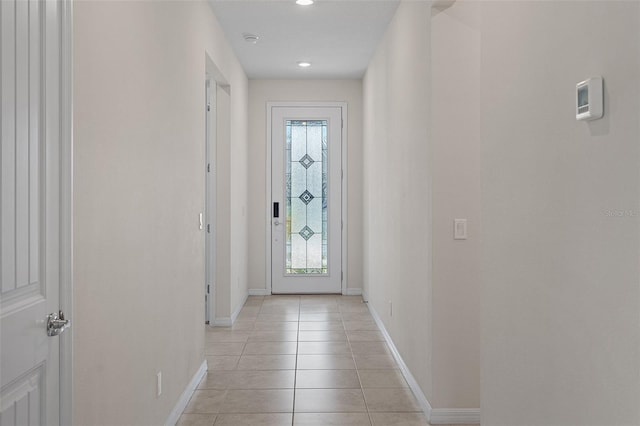 doorway to outside featuring light tile patterned flooring