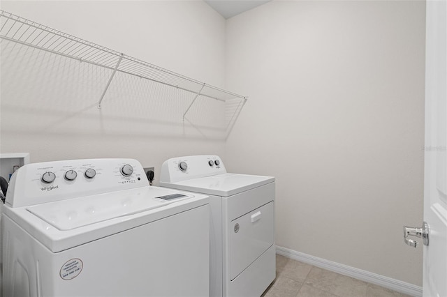 laundry room featuring washer and dryer and light tile patterned floors