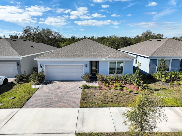 ranch-style home featuring a garage and a front yard