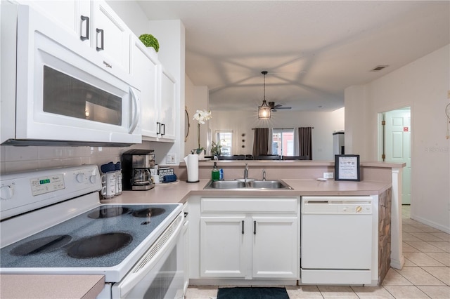 kitchen with sink, white appliances, backsplash, white cabinets, and light tile patterned flooring