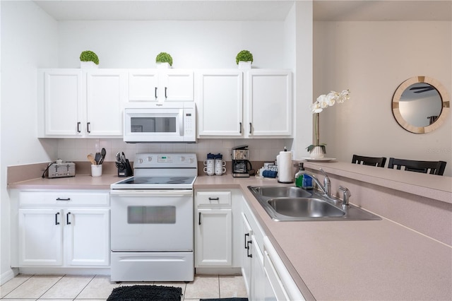 kitchen with white cabinetry, white appliances, and light tile patterned floors