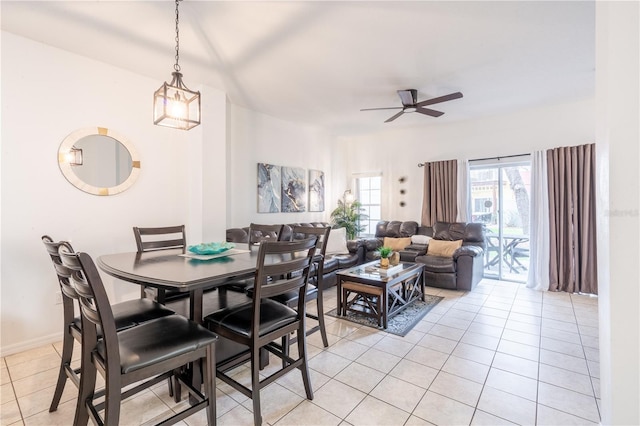 dining space featuring light tile patterned floors and ceiling fan