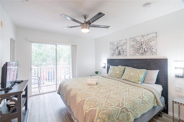 bedroom with wood-type flooring, a textured ceiling, access to outside, and ceiling fan