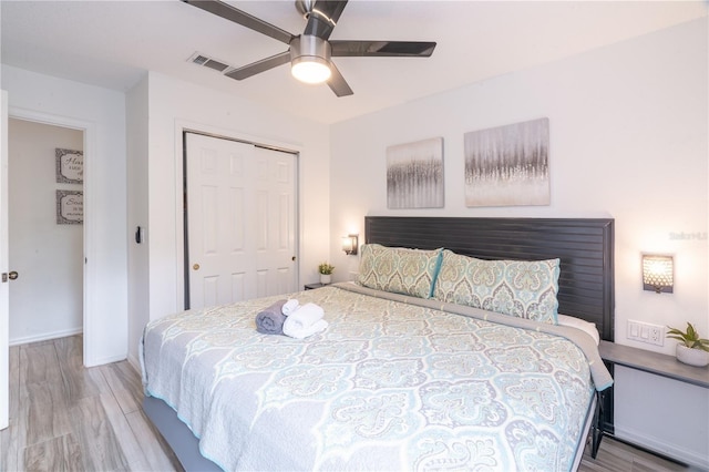 bedroom featuring light hardwood / wood-style floors, a closet, and ceiling fan