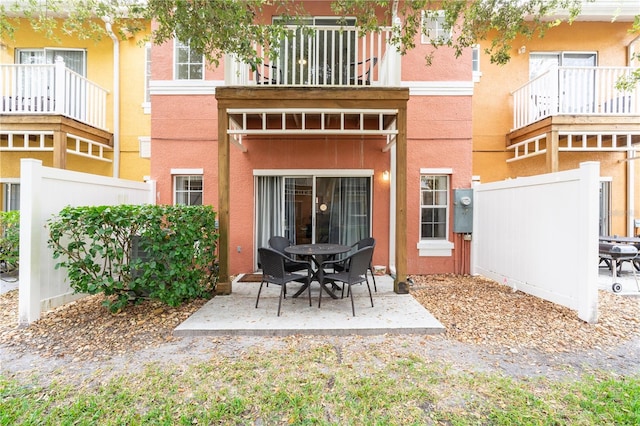 back of house featuring a balcony and a patio area