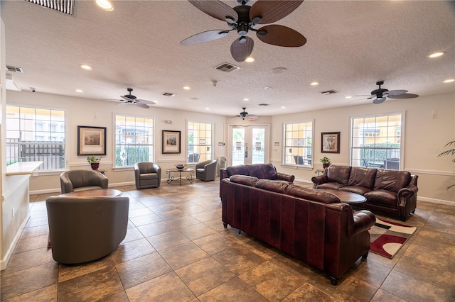 living room with a healthy amount of sunlight and a textured ceiling