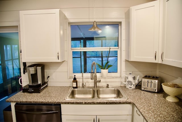 kitchen with sink, black dishwasher, and white cabinets