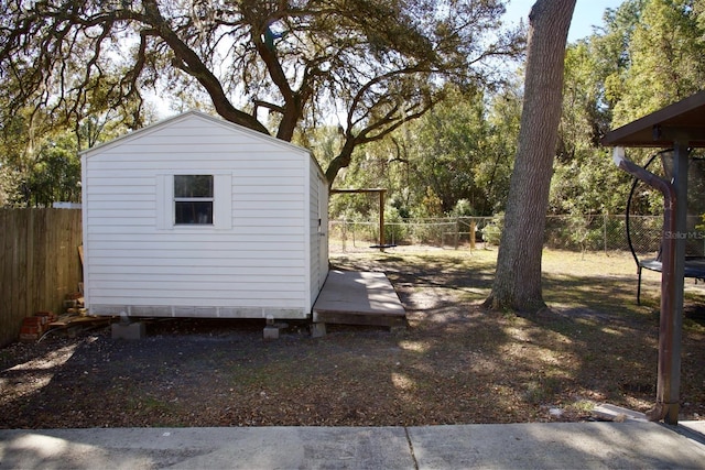 view of yard featuring a trampoline and a storage unit