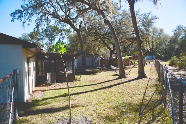 view of yard with central AC unit and a sunroom