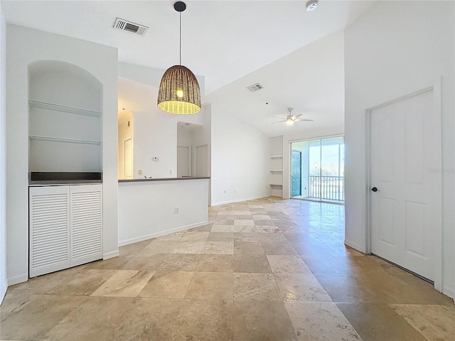 interior space with built in shelves, ceiling fan, and vaulted ceiling