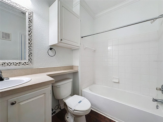 full bathroom featuring hardwood / wood-style floors, bathtub / shower combination, ornamental molding, vanity, and toilet